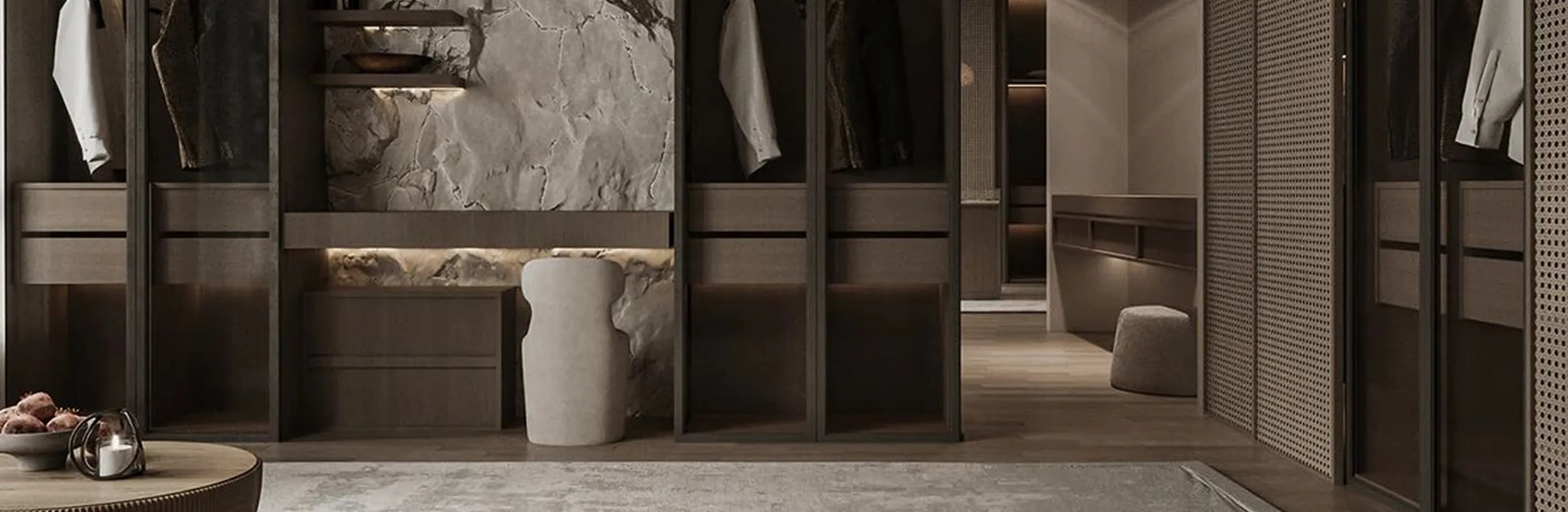 Luxury walk-in wardrobe with dark wood and LED lighting featuring bespoke joinery.