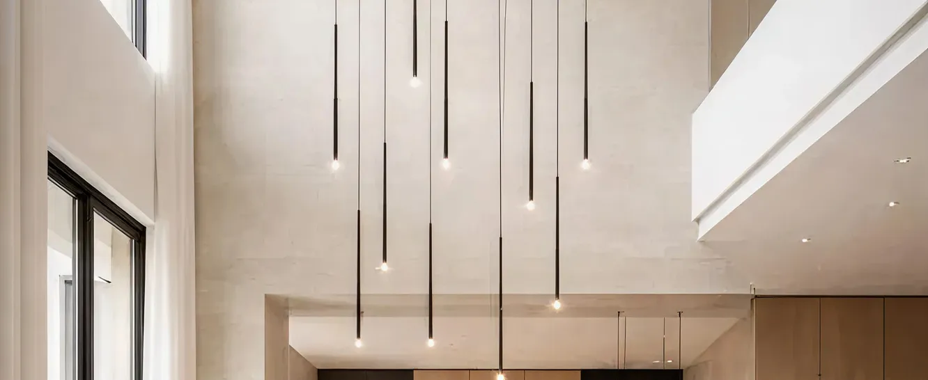 Luxury entrance design featuring statement chandeliers and pendant lighting.