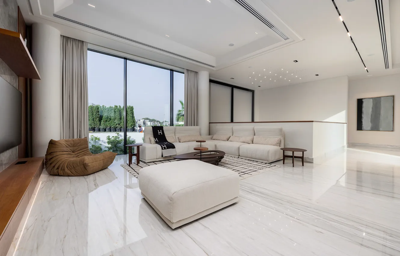 Modern turnkey fit-out with marble coffee table and designer lighting.