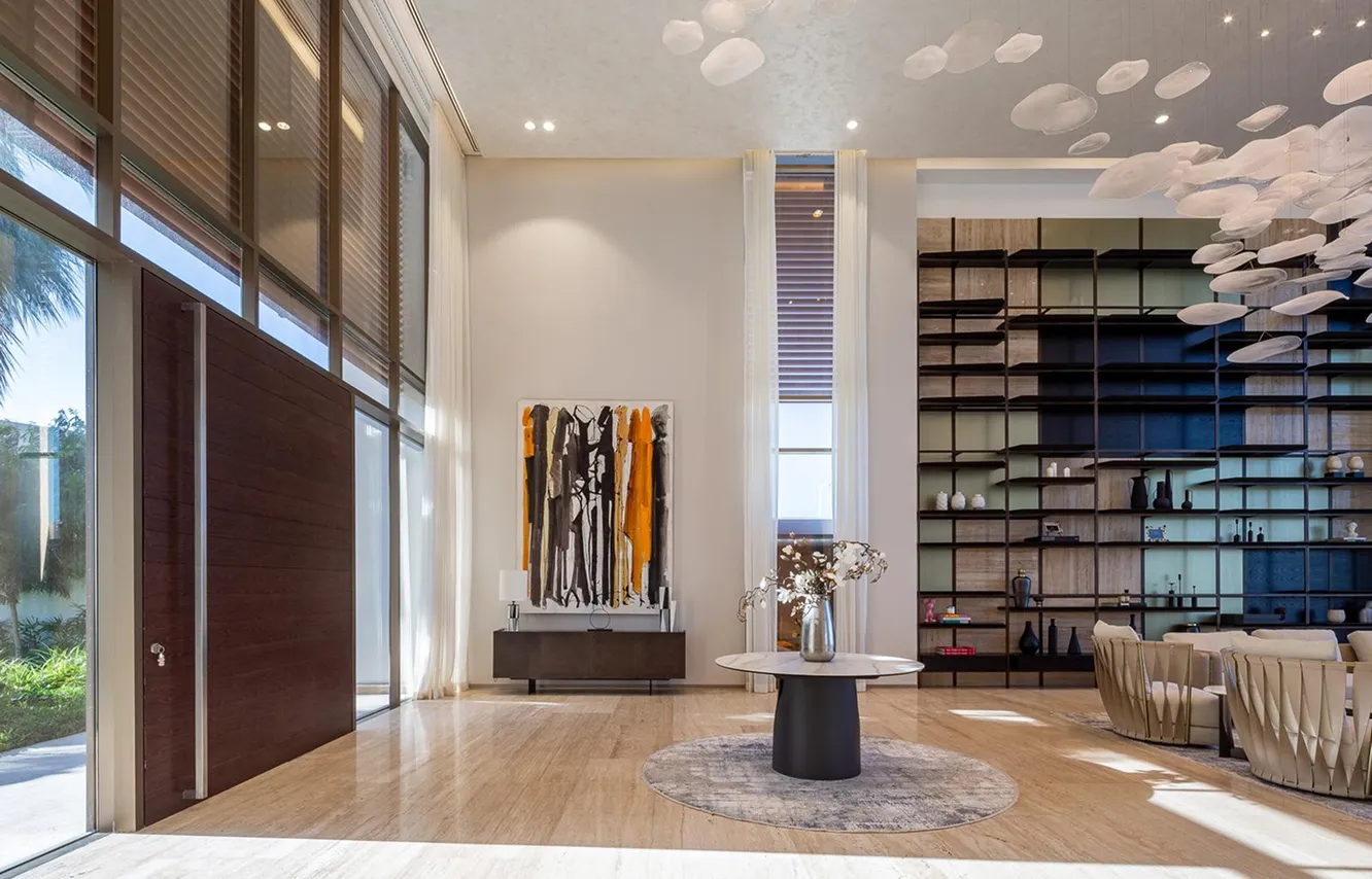 Modern foyer design with marble console and floating staircase in a luxury villa.