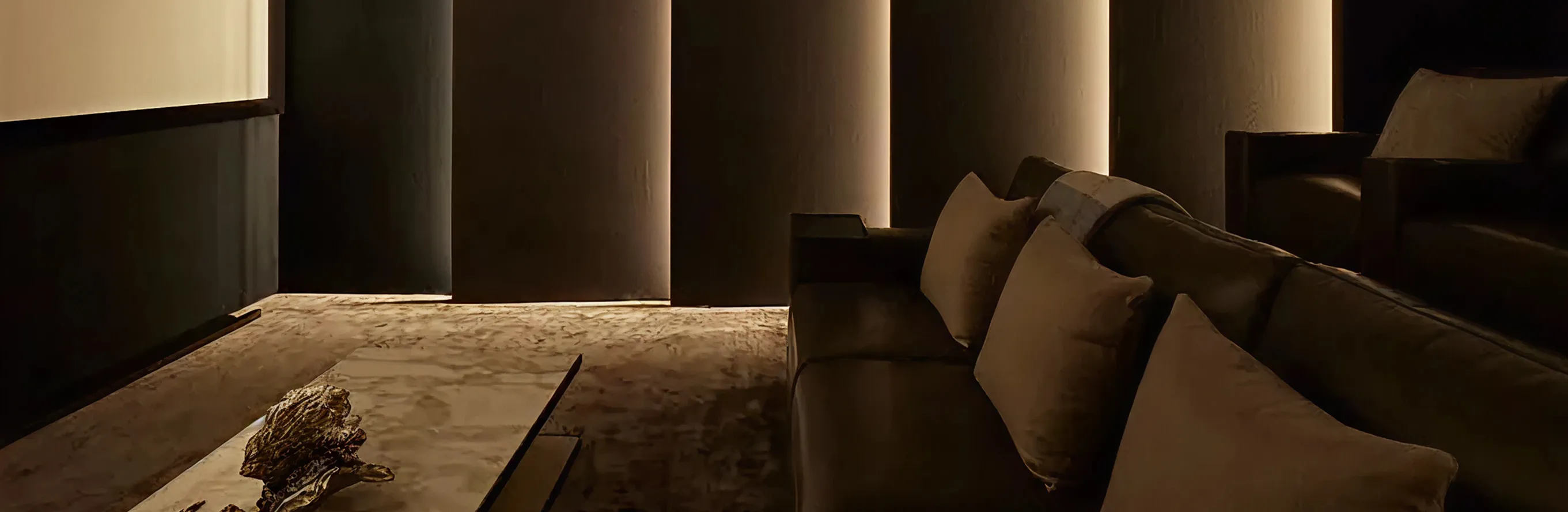 Luxury home theater room interior featuring layered recliners and premium finishes in Dubai.