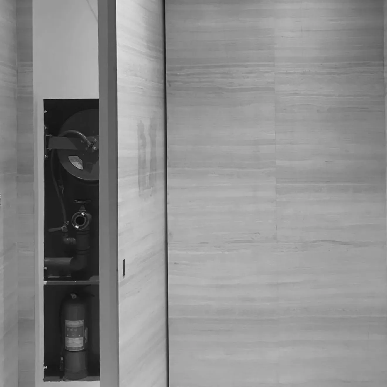 Rayfitout fire compliance fit out with concealed hose reel and extinguisher.