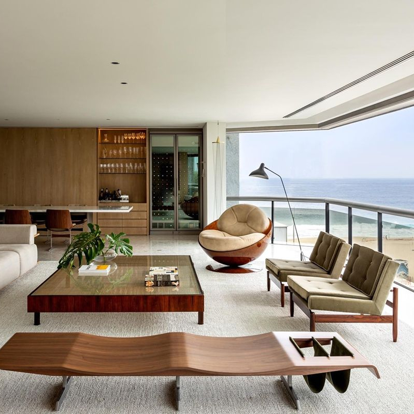 Minimalist living room interior design with floor-to-ceiling windows.