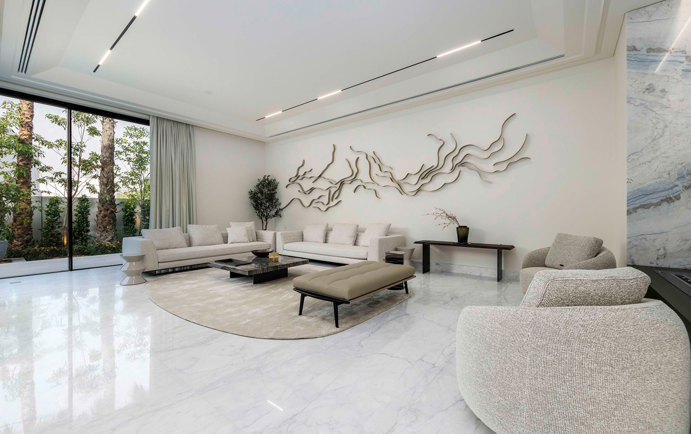 Modern living room interior featuring built-in bookshelf and bespoke joinery in Abu Dhabi.