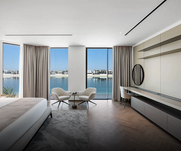 Modern beachfront villa with expansive windows at Palm Jumeirah, Dubai.