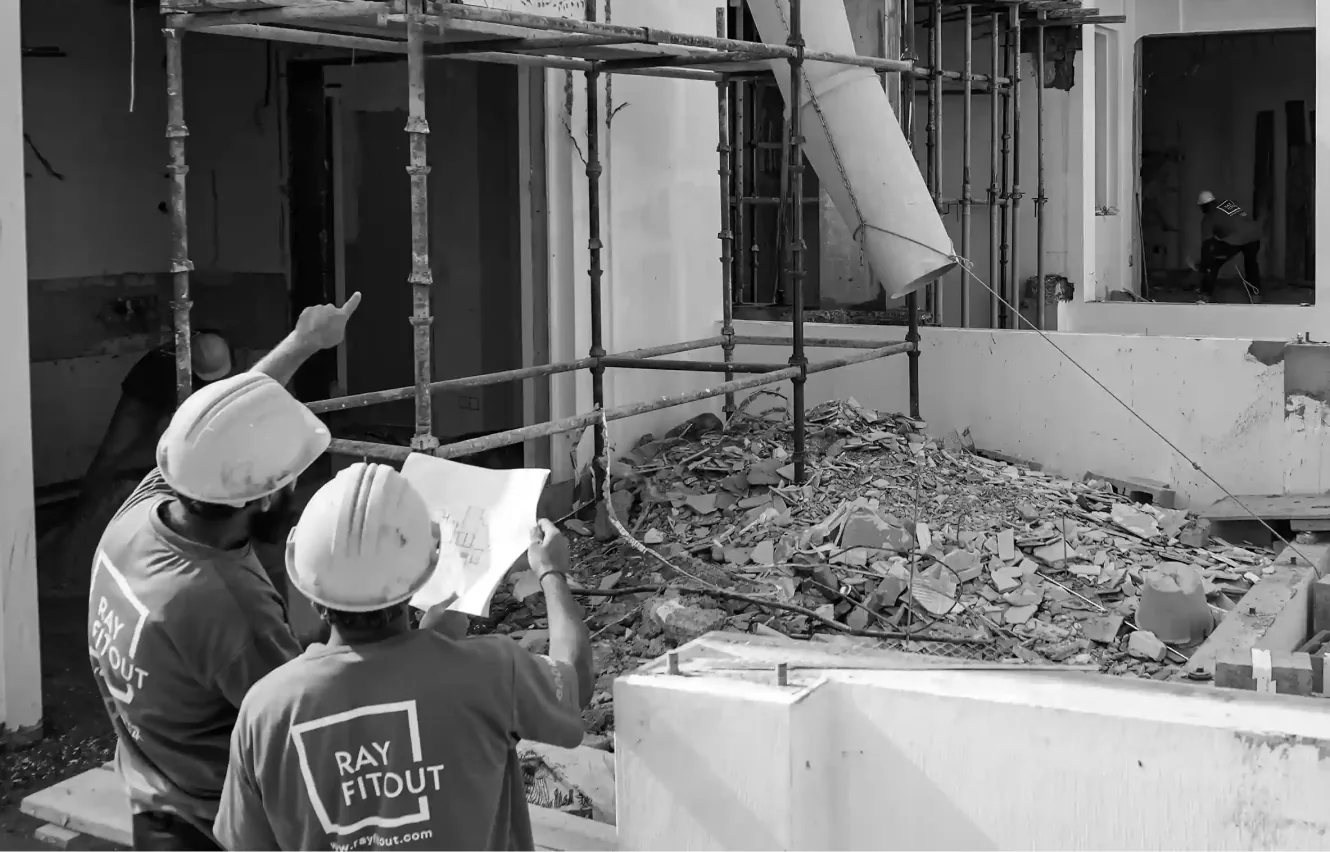 Rayfitout design and build team reviewing plans on a villa renovation site