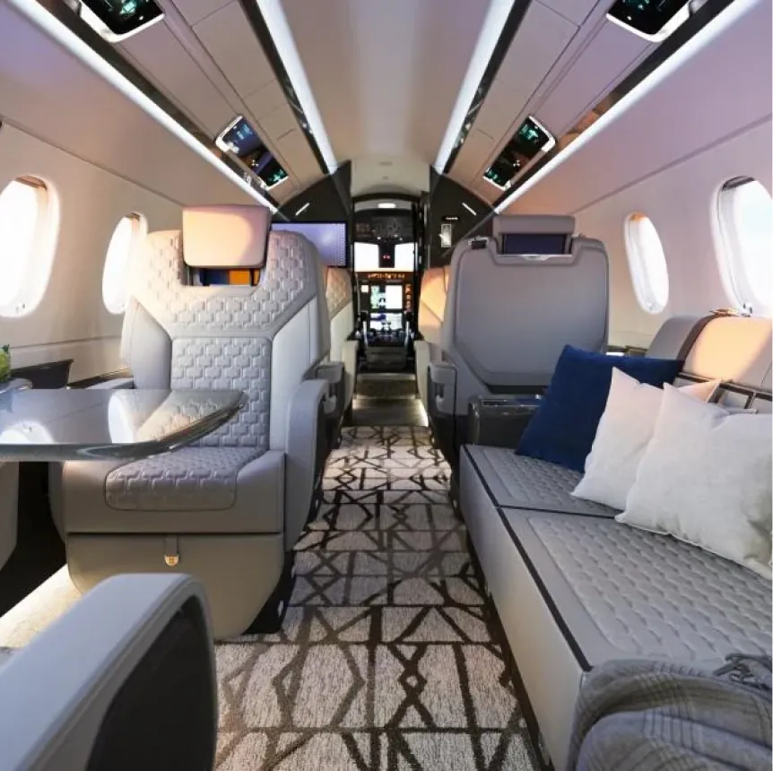 Embraer private jet cabin with quilted seats and divan