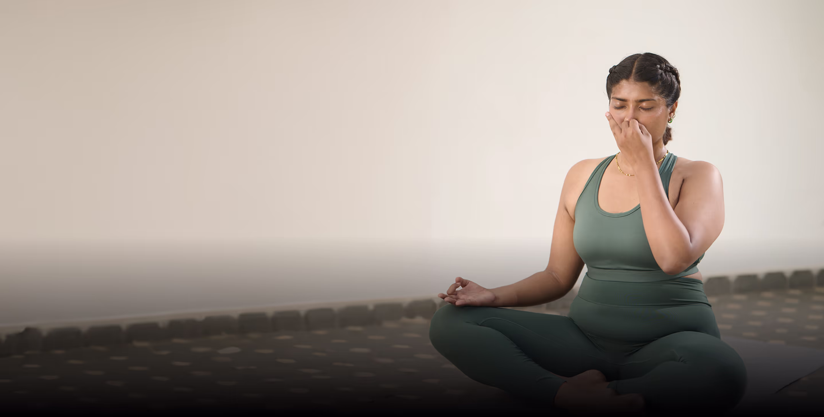 Woman doing breathing exercises in a live online pranayama class with Shvasa