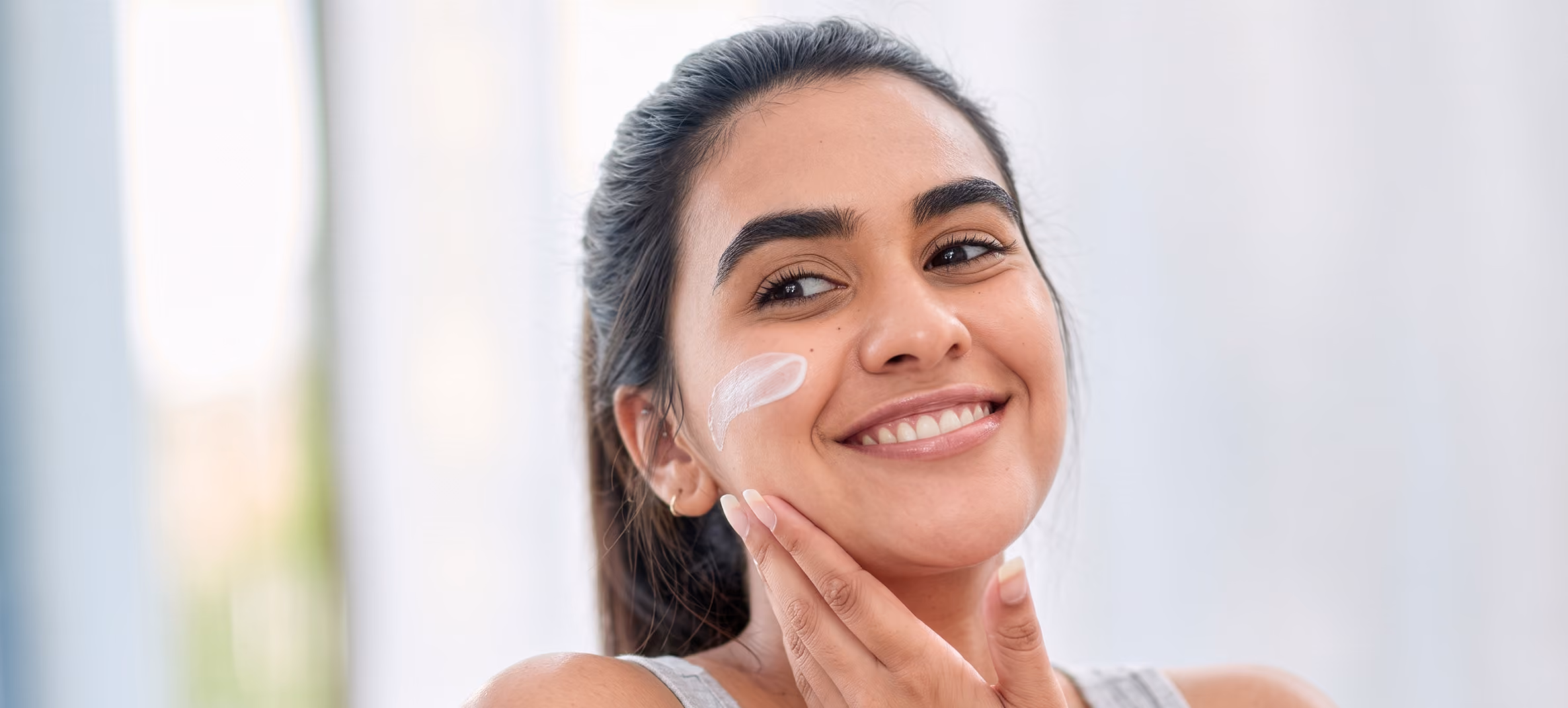 Face Yoga benefits showing a smiling woman in soft natural light.