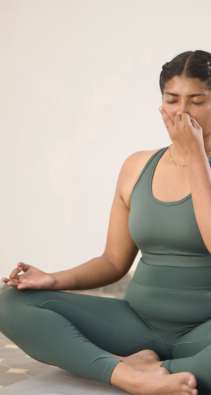 Woman doing breathing exercises in a live online pranayama class with Shvasa