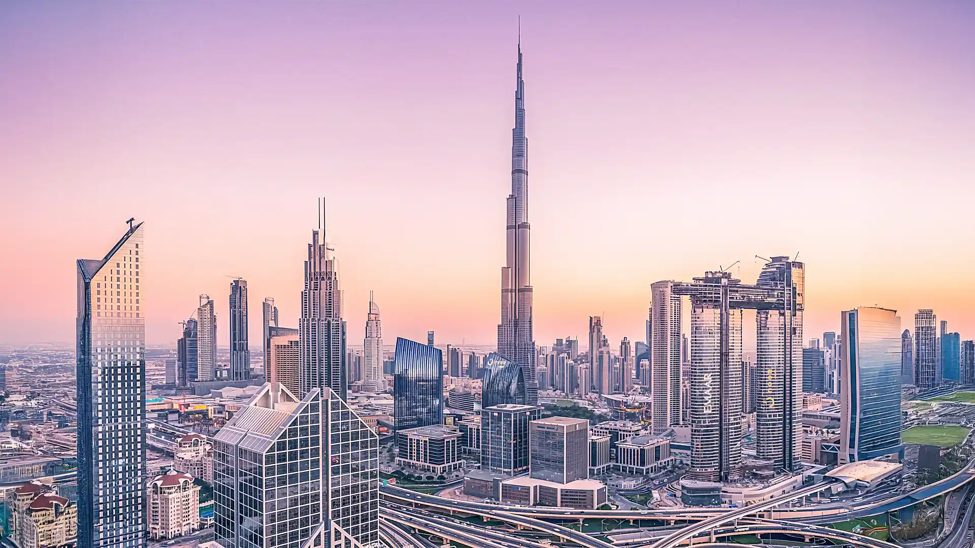 Panoramic view of Dubai skyline at sunset with Burj Khalifa and modern skyscrapers, UAE