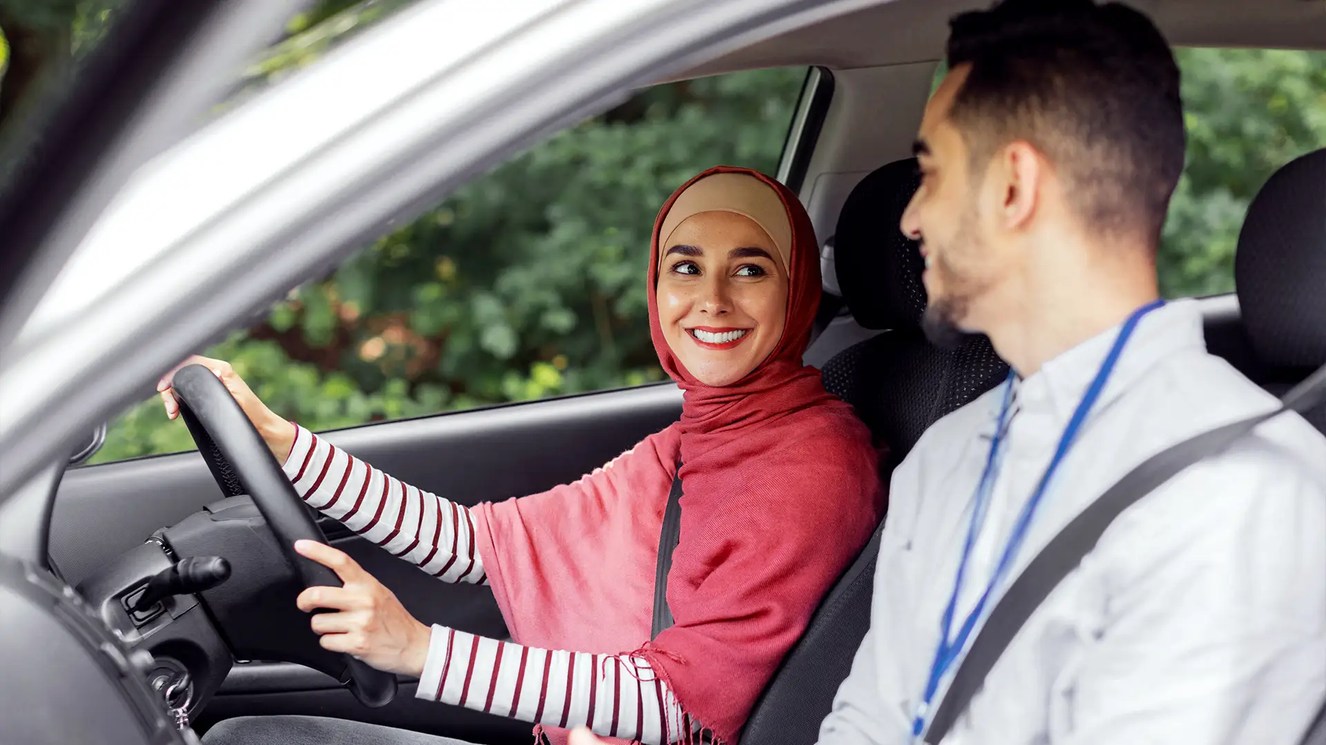 Driving instructor man tutoring a woman