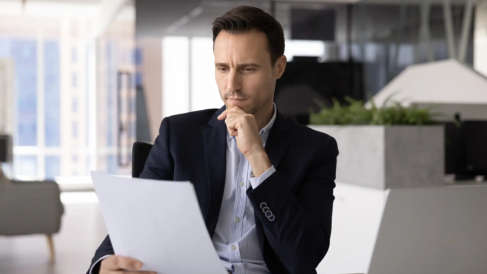 Man in a suit holding documents, Document Notarization in Dubai