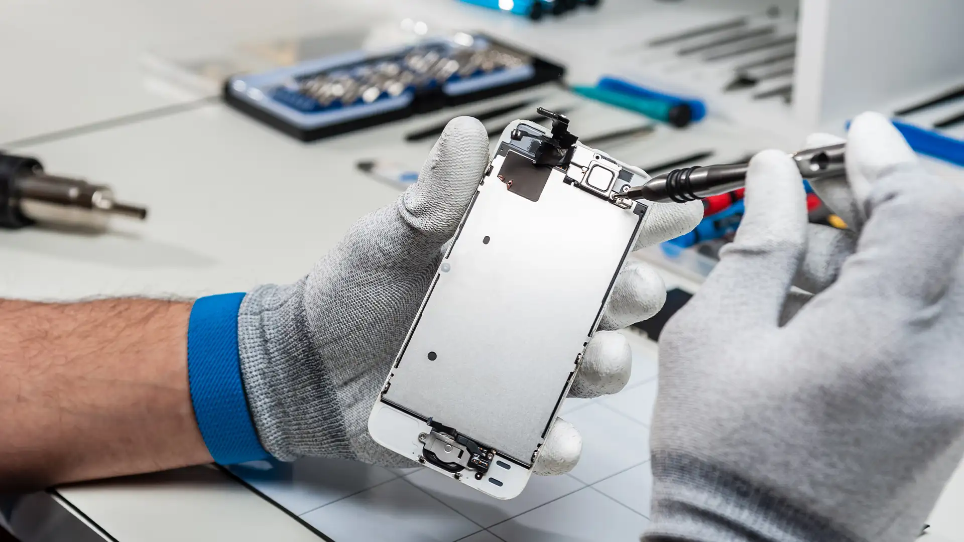 Man repairing a phone, phone installation repair business in dubai