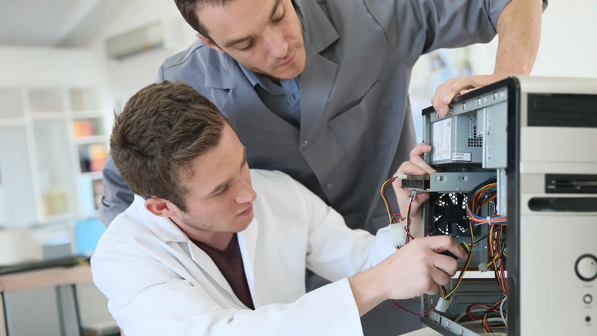 2 Men repairing a computer as a part of training. Computer Repair Training Institute business setup in Dubai