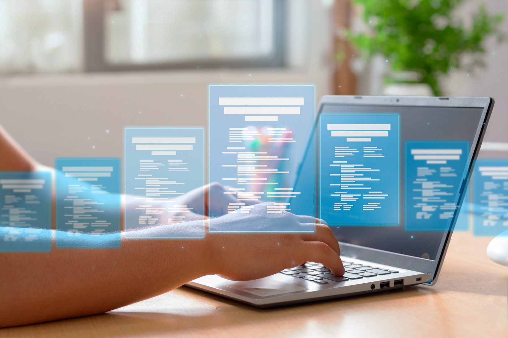 Person working on a laptop with digital files and folders visualized as floating icons
