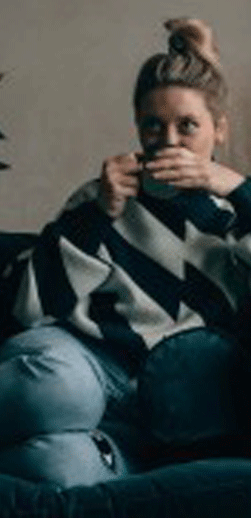 Client sat on sofa with cuppa tea 