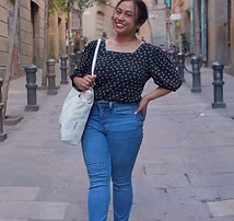Ms. Islam smiling while walking outdoors