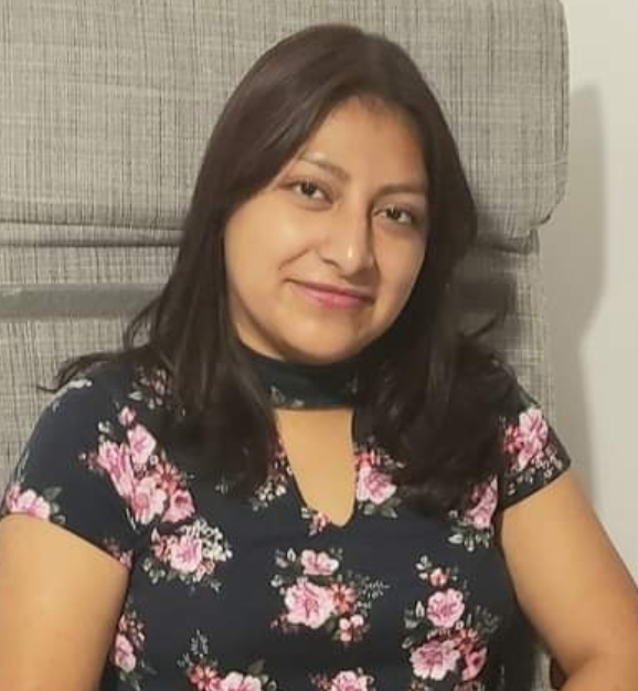 Ms. Sanchez smiling in a floral top staff photo