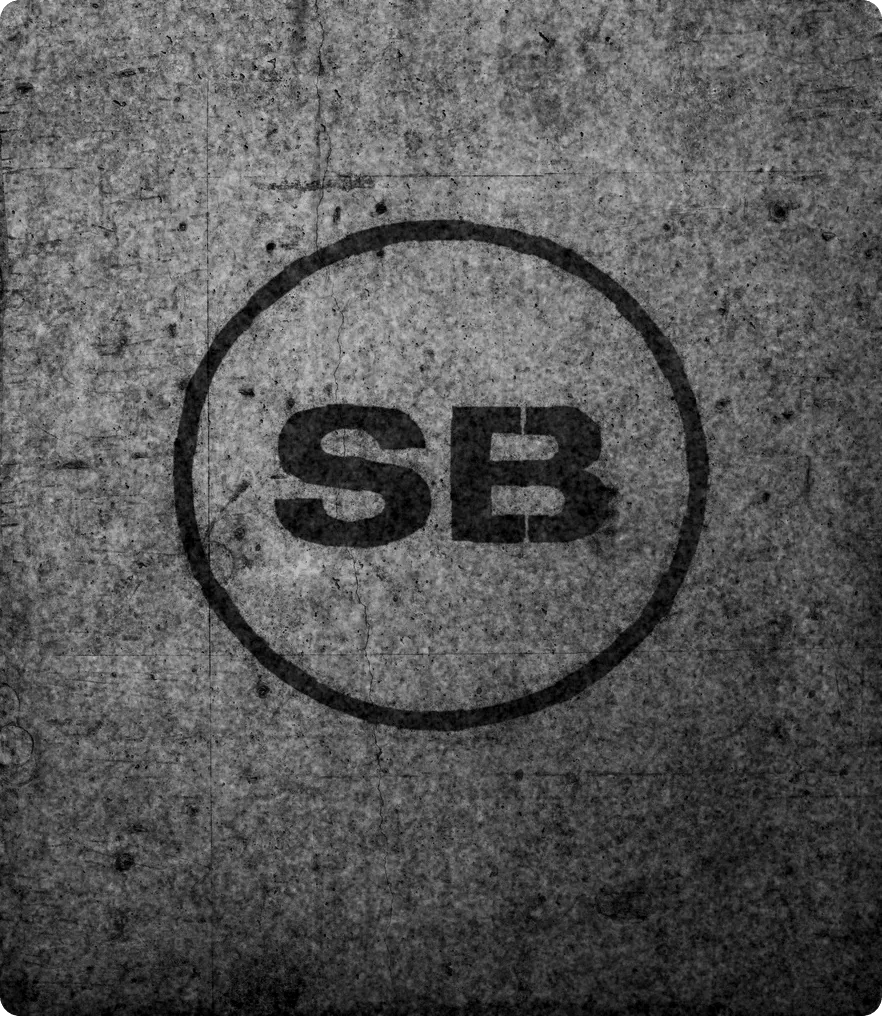 The SportsBoss SB mark stencilled in spray paint on a weathered concrete wall.