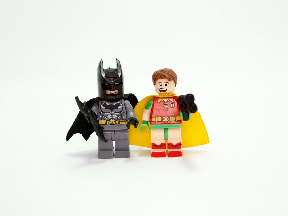 Picture of Batman and Robin Lego figures standing side by side on white background