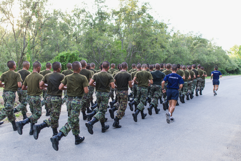 Group of soldiers running information backs to the camera