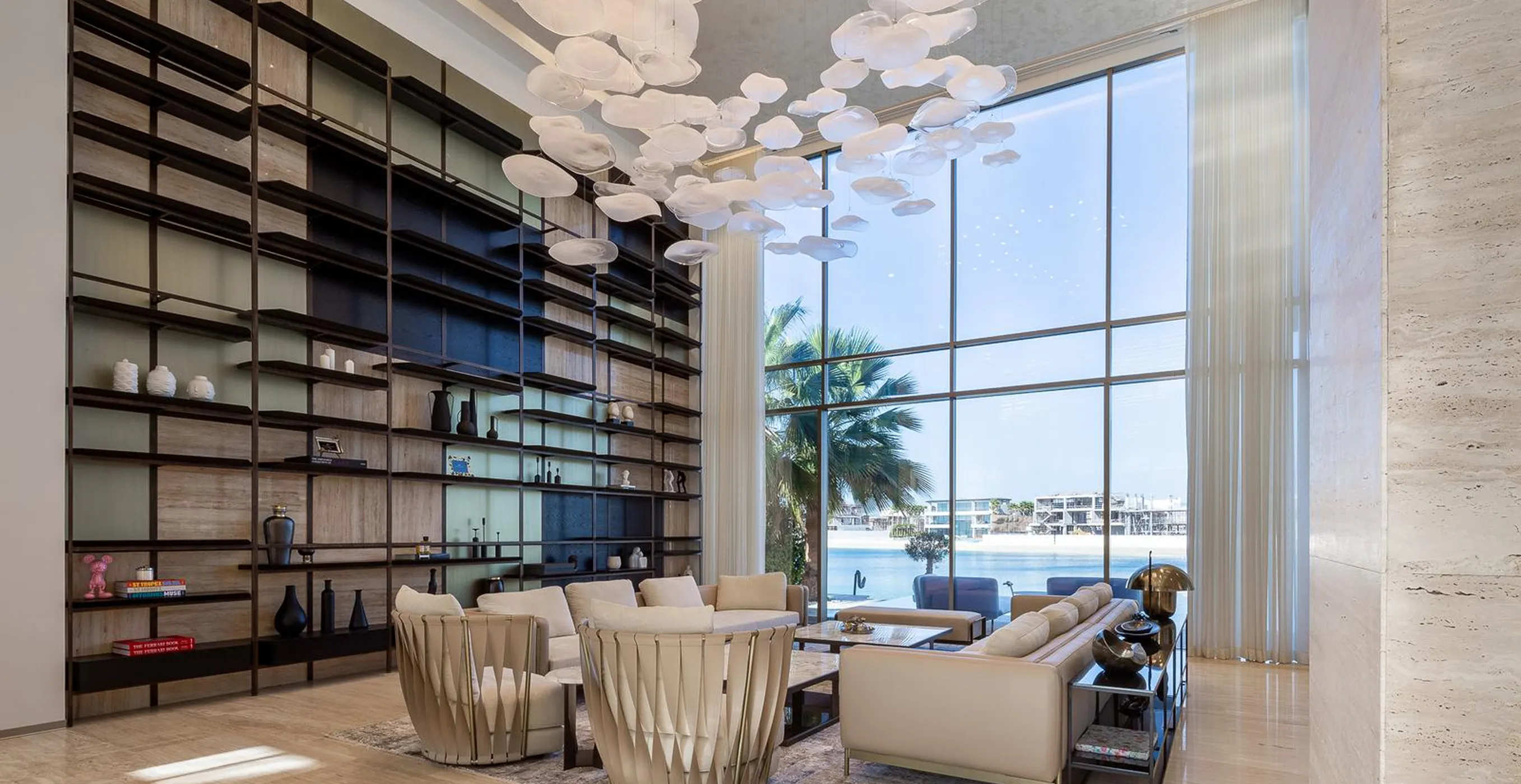 Modern living space with modular sofas and floor-to-ceiling windows in a private villa, Palm Jumeirah.