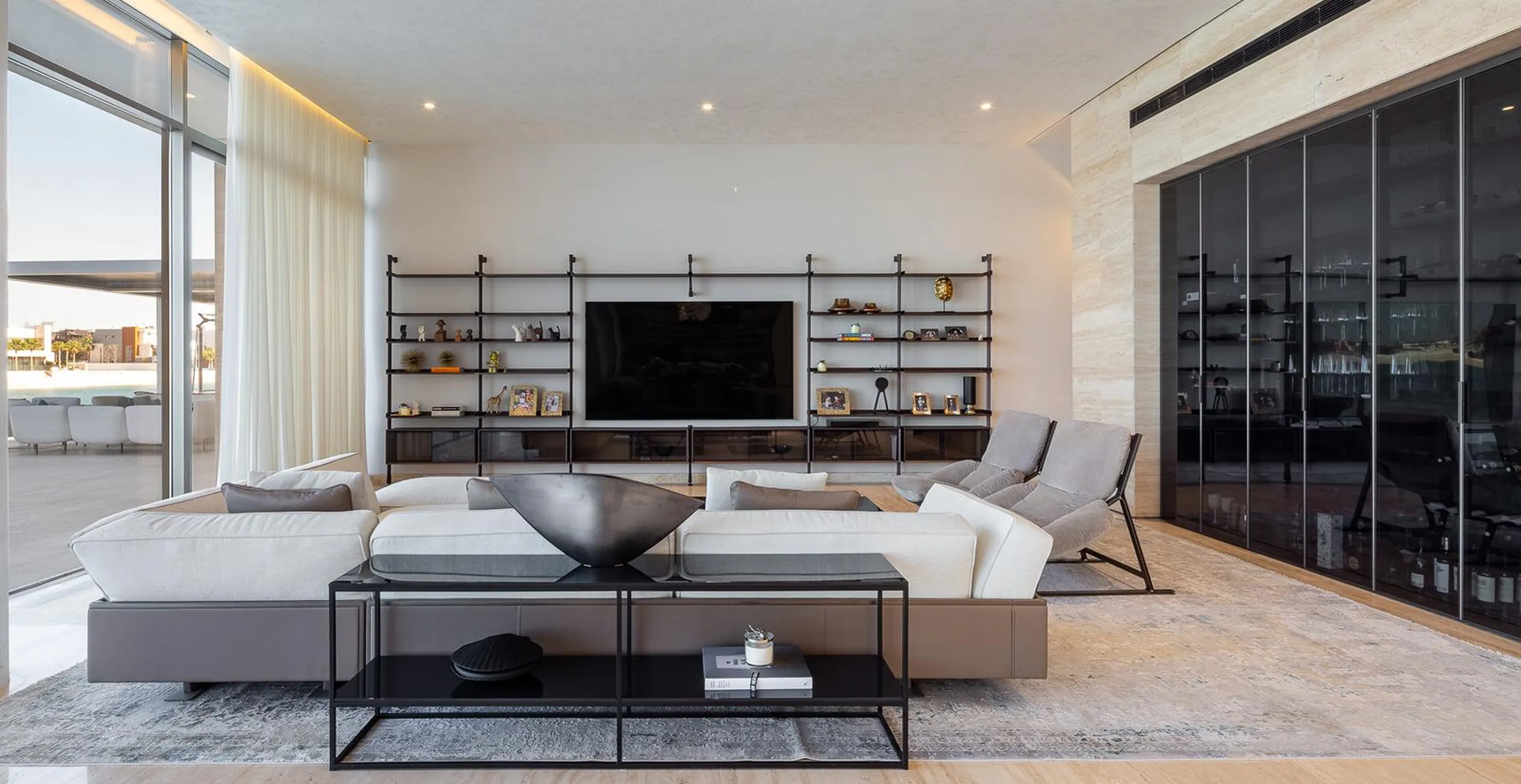 Modern living room interior fit-out with wall-mounted TV and modular sofas.