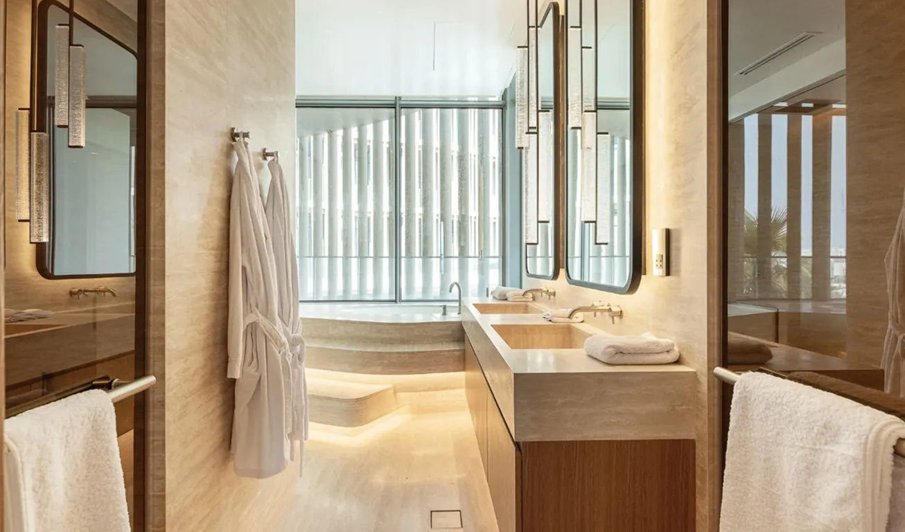 Contemporary villa bathroom interior fit-out in Palm Jumeirah with large bathtub and expansive windows.