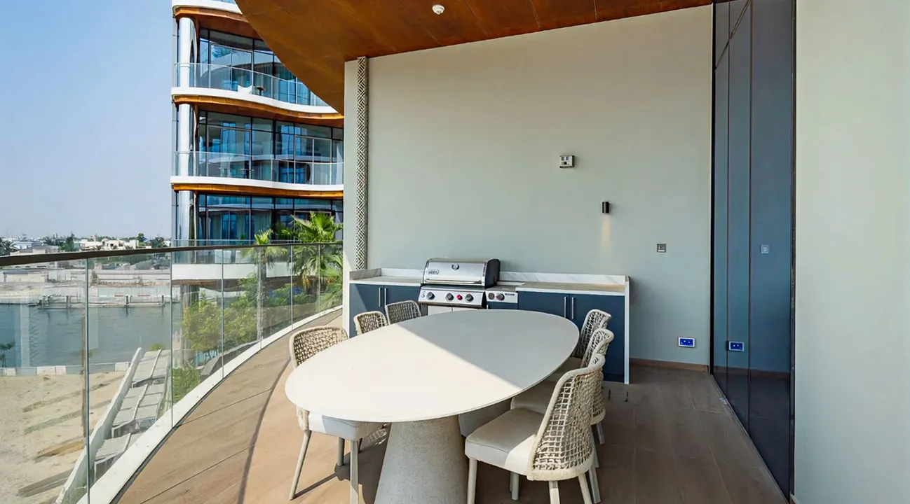 Modern terrace interior fit out with dining area and waterfront view in Palm Jumeirah.