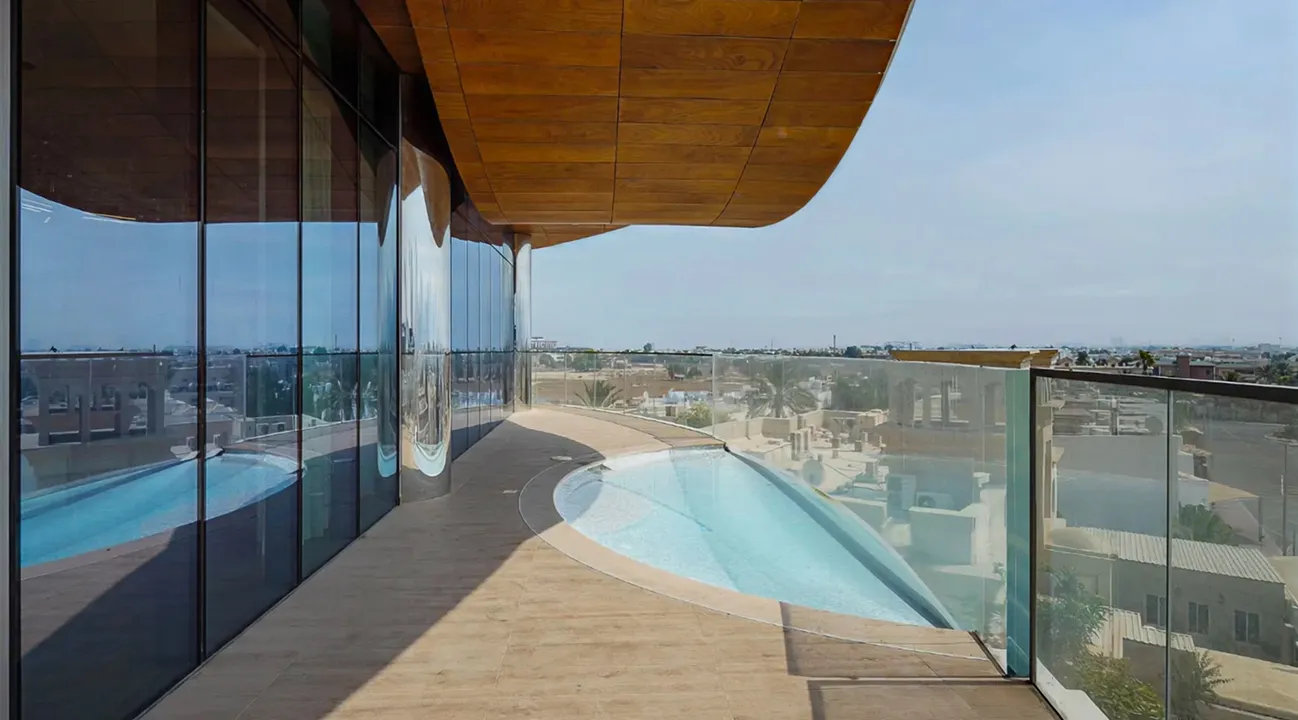 Modern outdoor terrace interior fit out with curved plunge pool and city view.