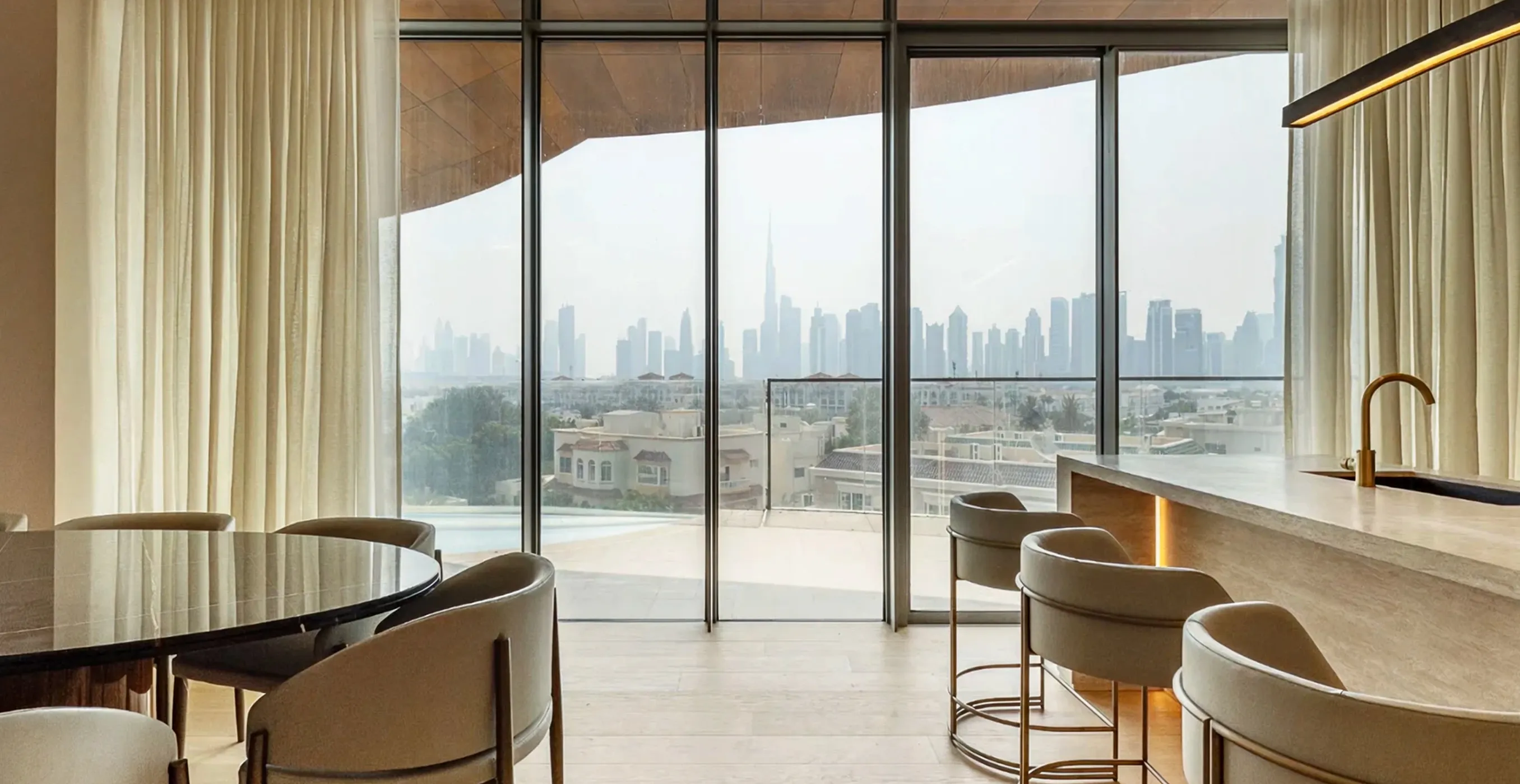 Luxury interior fit out with dining and kitchen space facing Burj Khalifa views.