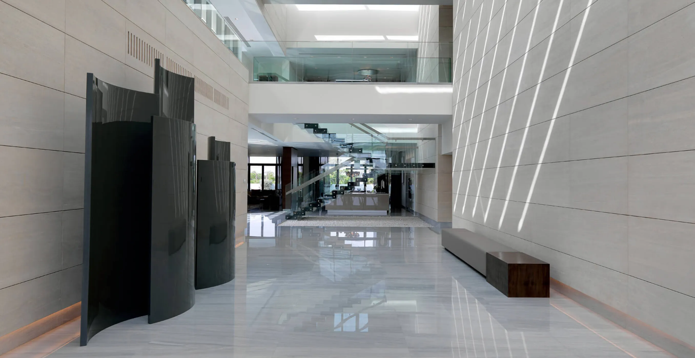 Minimalist interior fit-out featuring grey textures and open-plan design in Dubai.