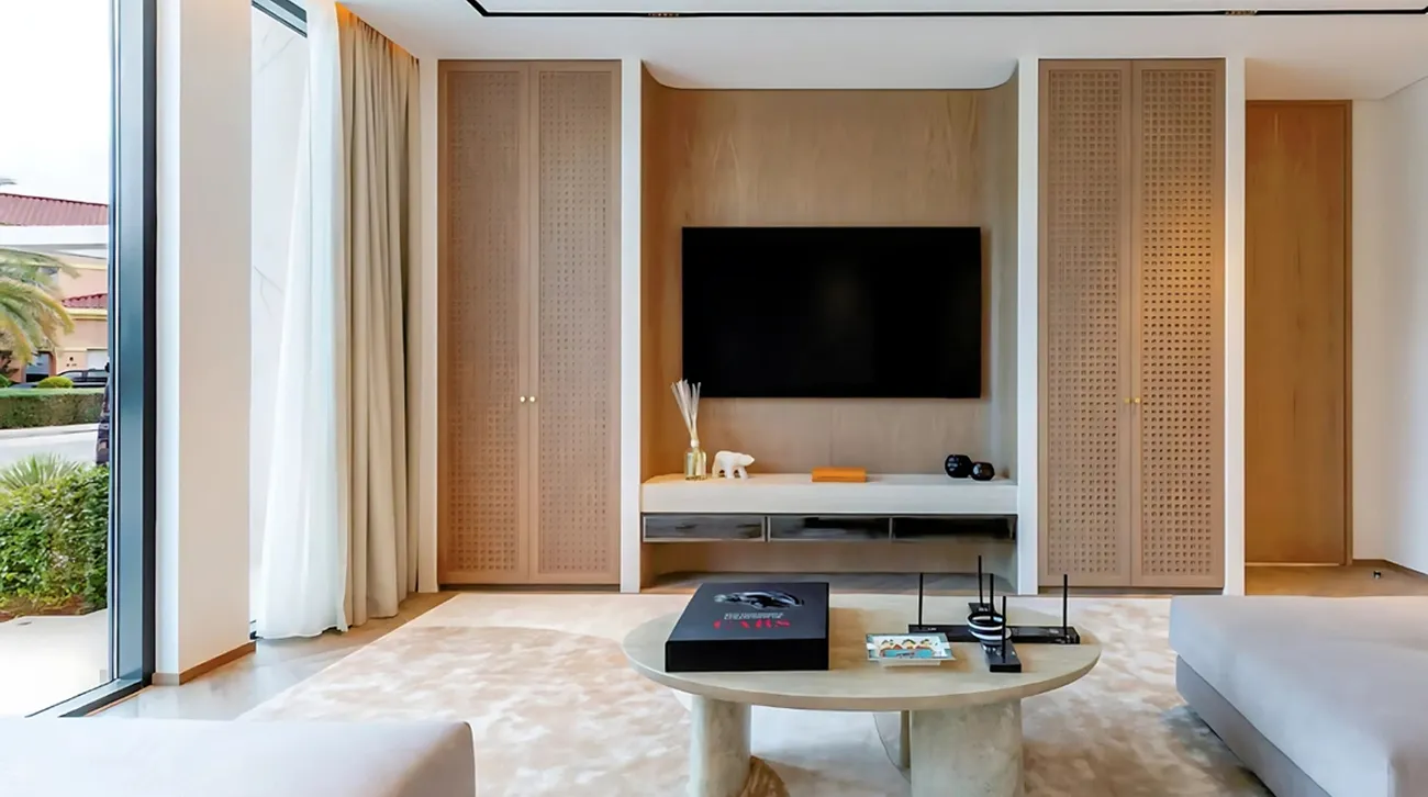 Modern living room interior fit-out with wall-mounted TV and media console.
