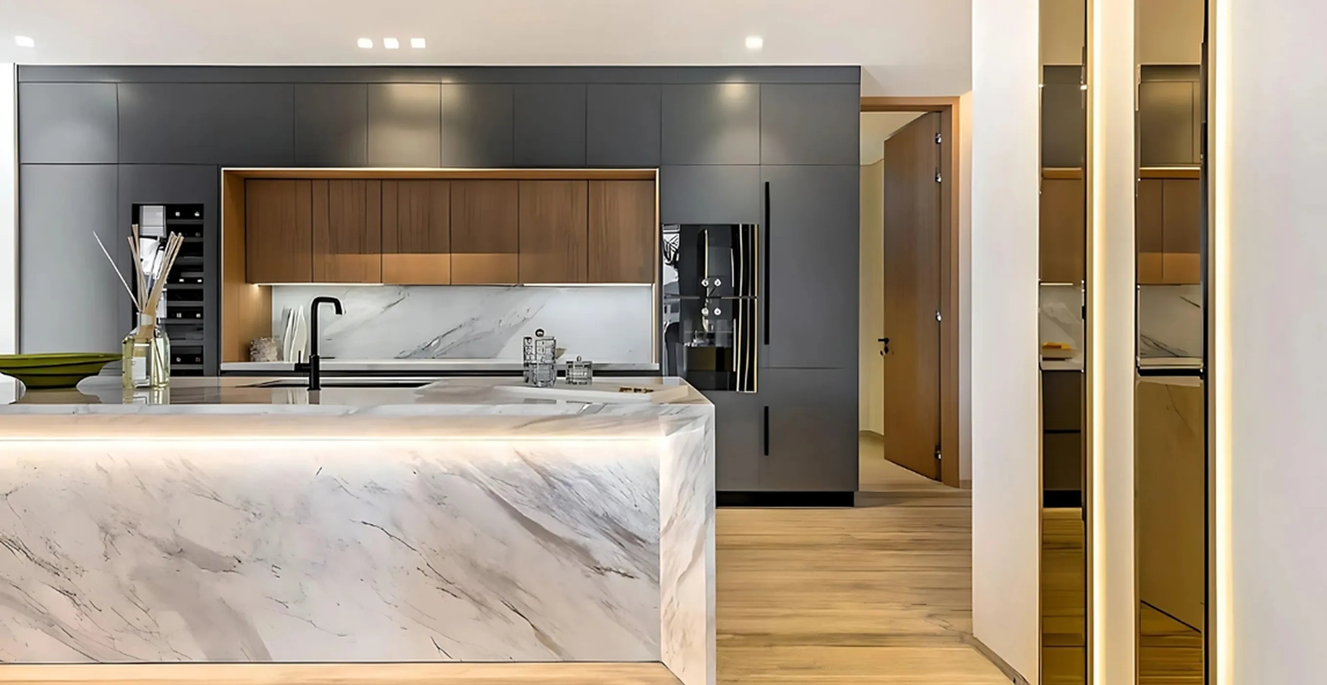 Contemporary kitchen interior fit-out featuring a marble island and modern appliances.