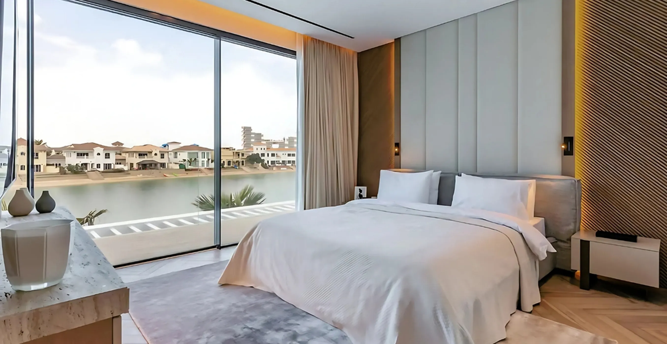 Luxury bedroom interior fit-out featuring floor-to-ceiling windows in a Signature Palm Villa.