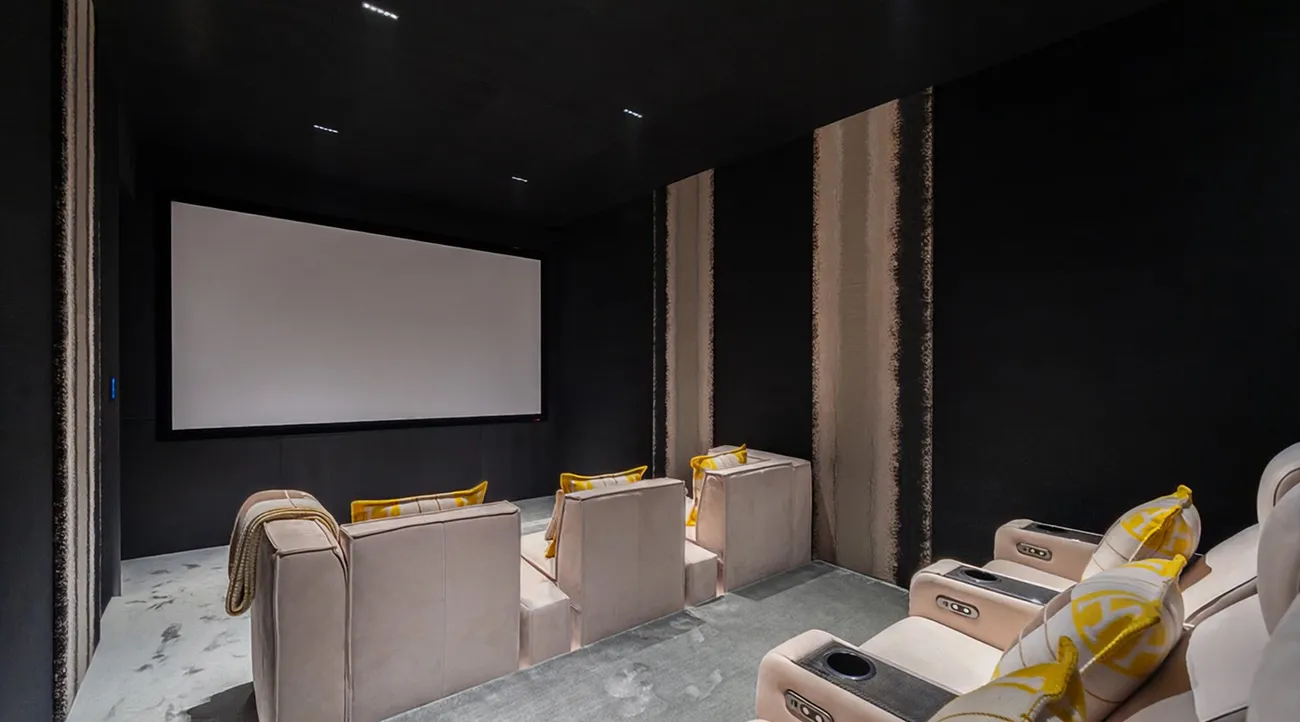 Private home theatre in a luxury villa, designed with plush seating and advanced audiovisual systems