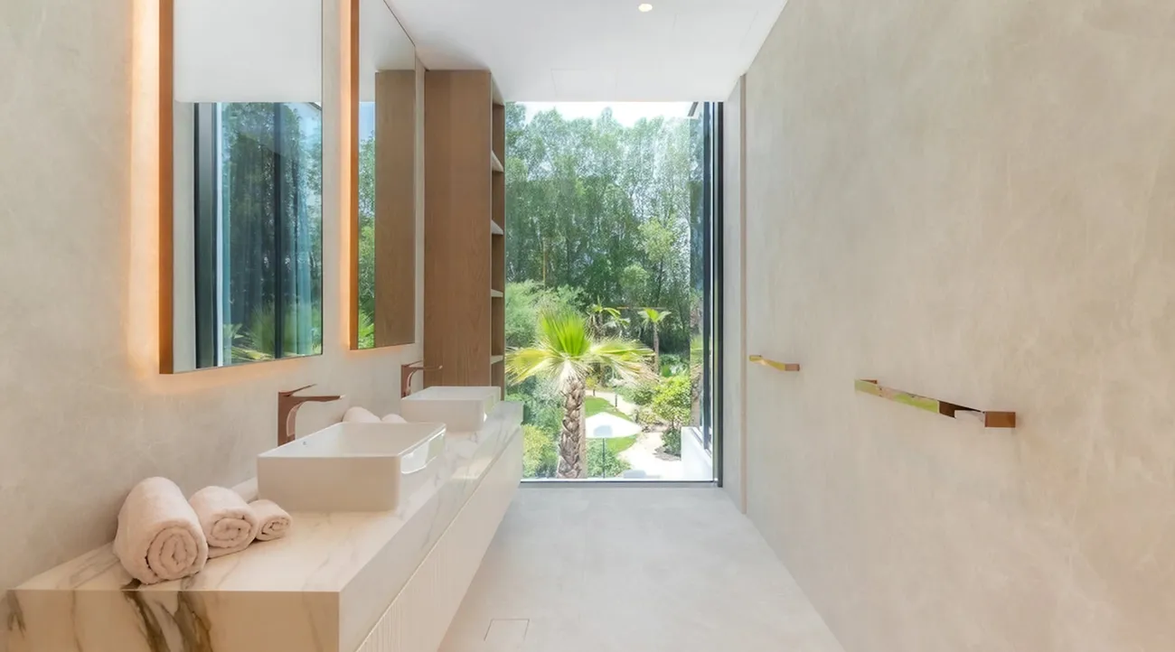 Modern bathroom with luxury finishes and dual sinks in a high-end villa