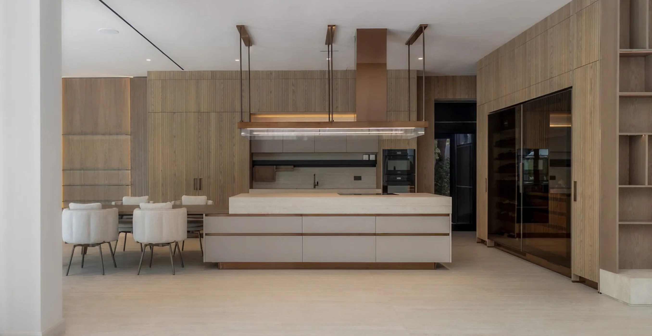 Luxury villa kitchen with custom-designed cabinets, concealed storage, and modular seating in Al Barari