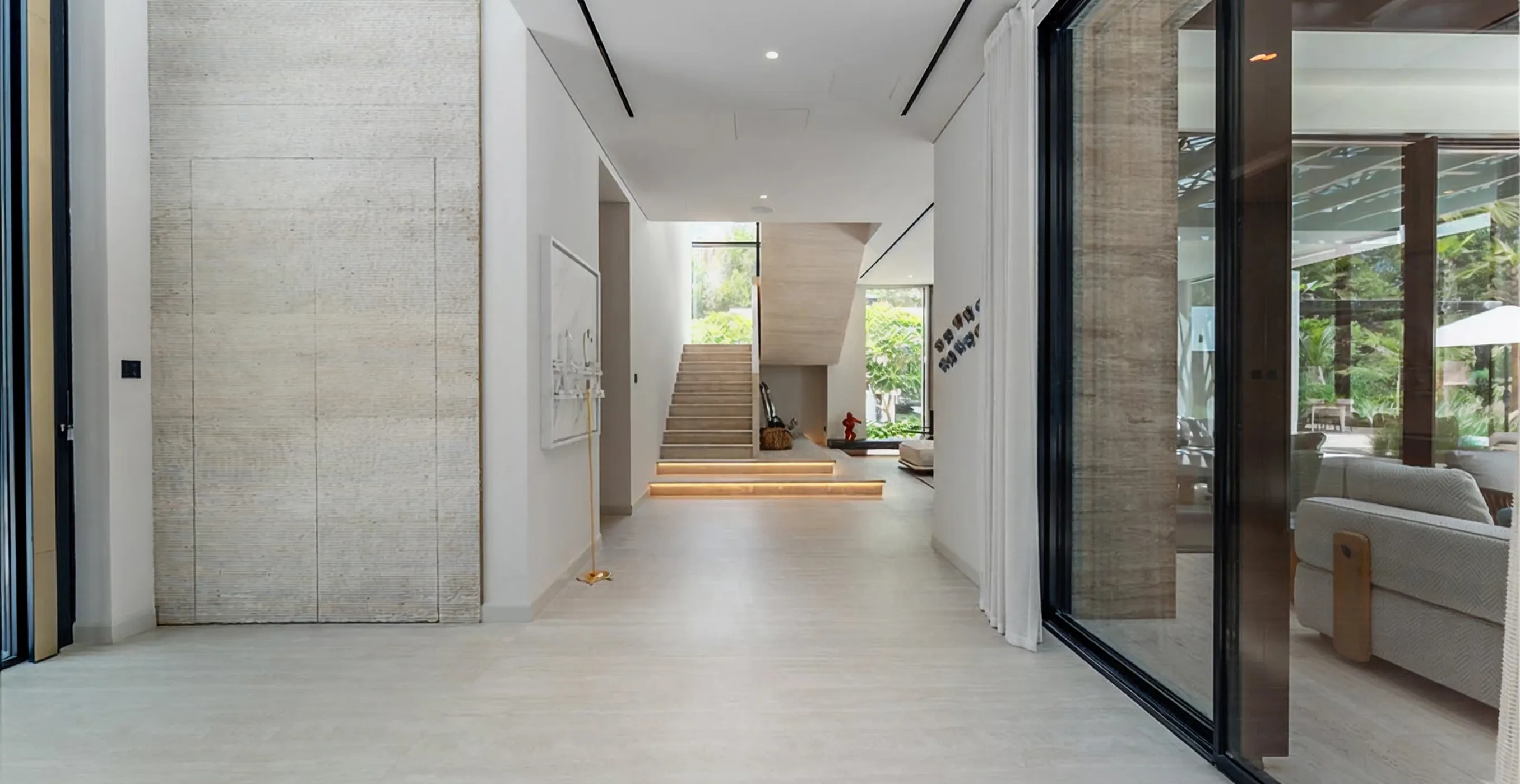 Interior design of a luxury villa in Al Barai featuring floor-to-ceiling glass and custom joinery