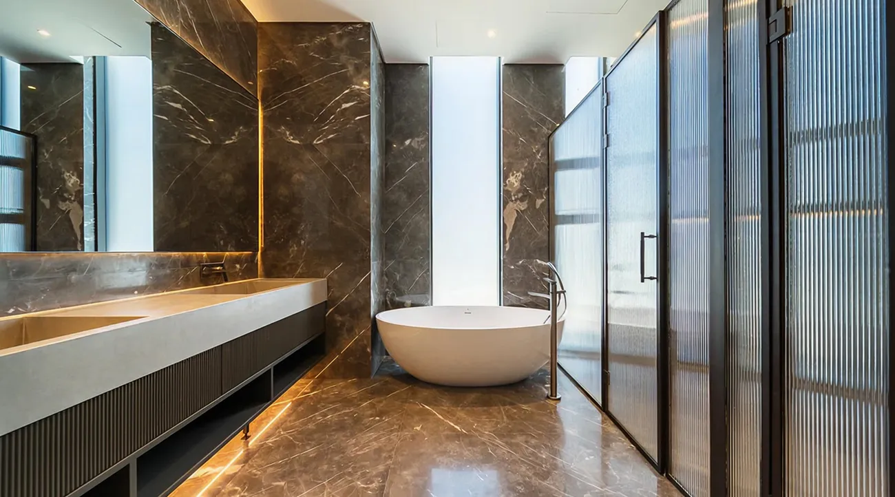 Luxury bathroom interior fit-out with marble finishes and freestanding tub in Dubai Hills.