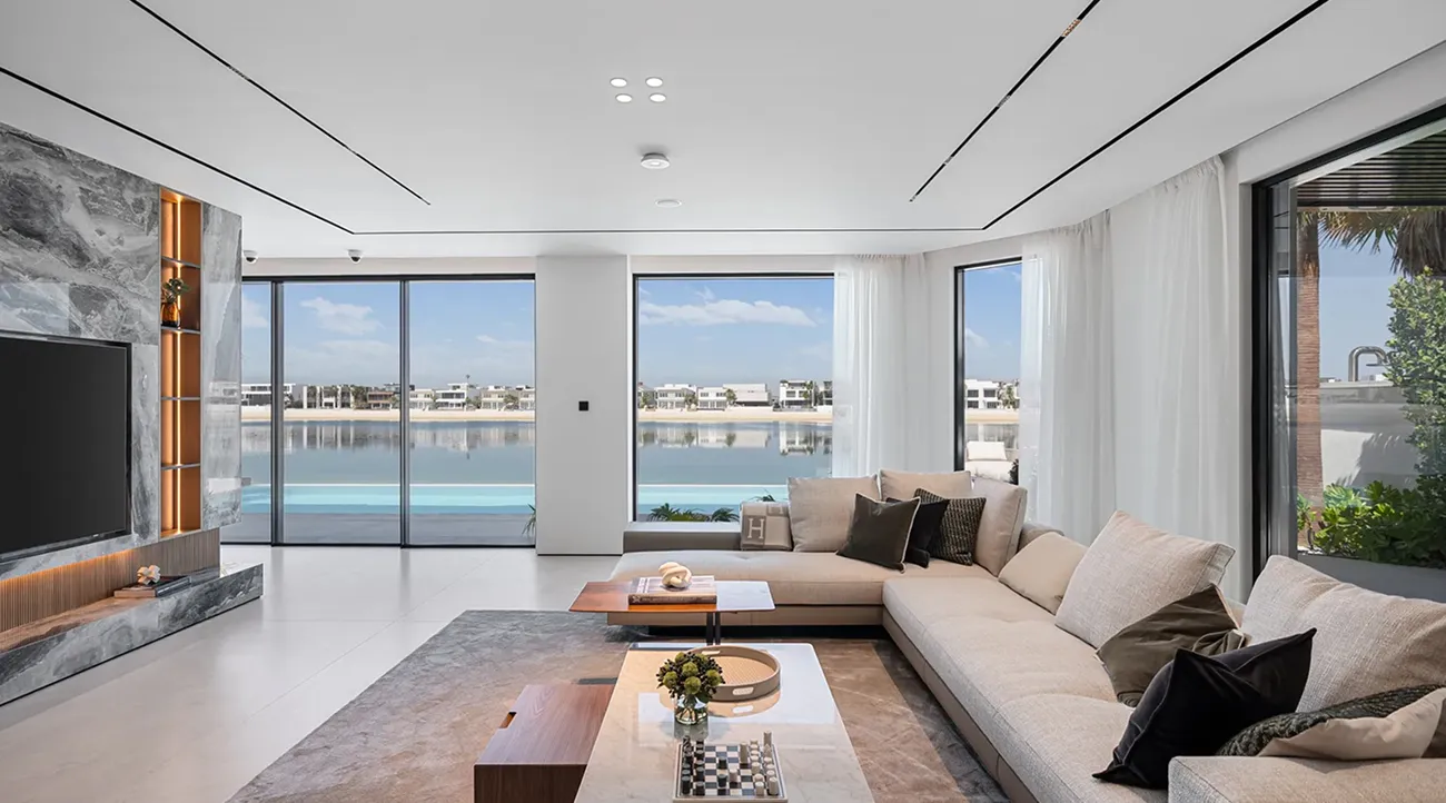 Luxury villa renovation in Palm Jumeirah featuring floor-to-ceiling windows and panoramic waterfront view.