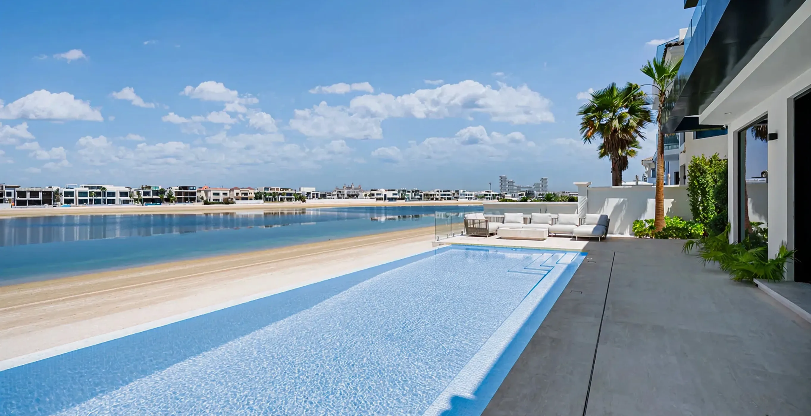 Renovated beachfront villa in Palm Jumeirah featuring infinity pool and panoramic water scene.