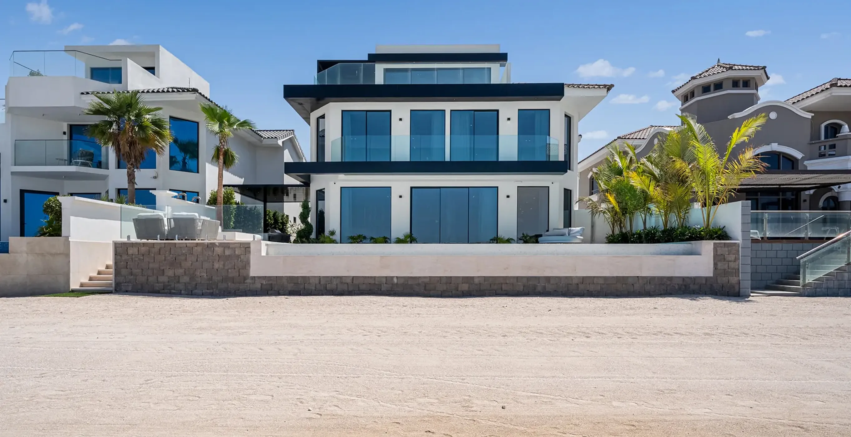 Modern luxury villa renovation with expansive windows on Palm Jumeirah beach by Rayfitout.