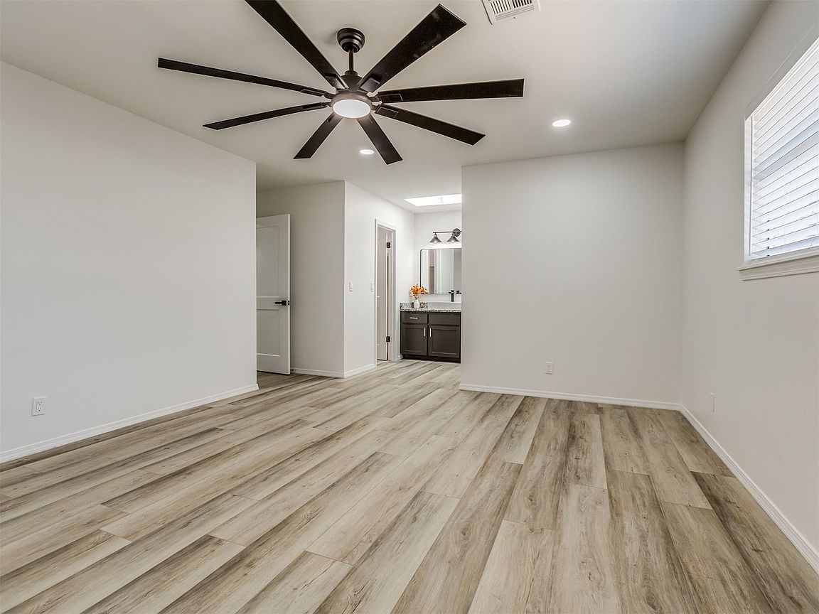 Bedroom with ceiling fan and updated flooring