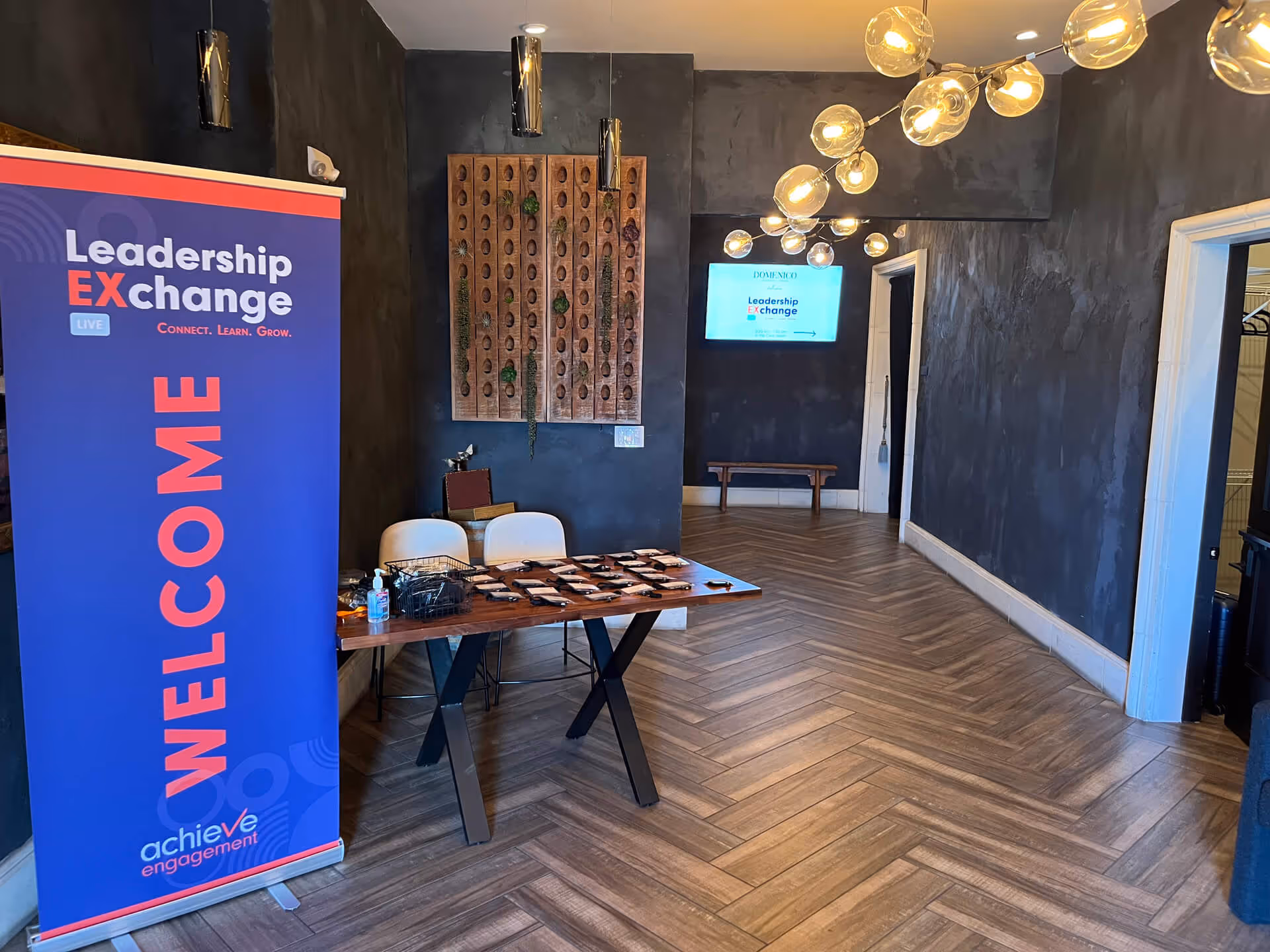 Leadership Exchange event setup with welcome banner and modern interior design