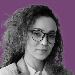 A woman wearing glasses and a white shirt.
