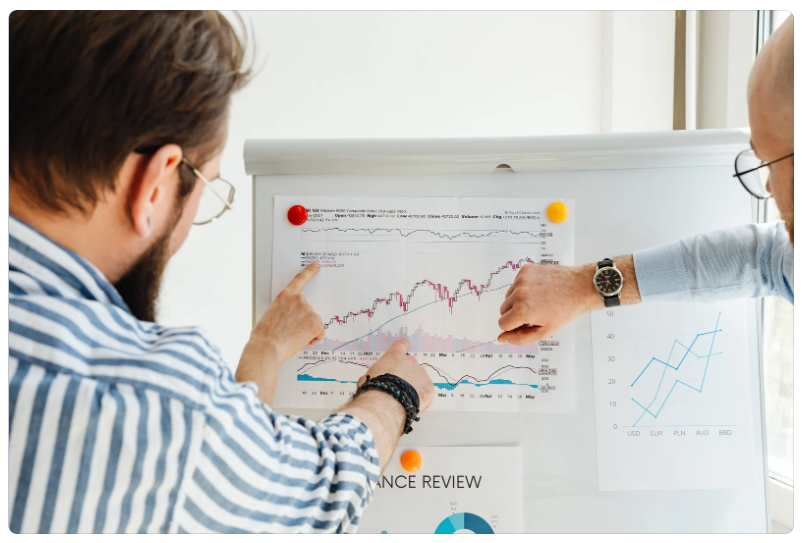 Team reviewing charts and metrics on a whiteboard, illustrating how Snowflake’s core concepts can be understood in plain language to help business users interpret data and reports with confidence. i-radius