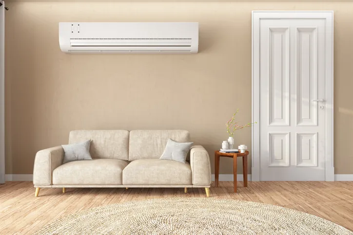 A living room featuring a white air conditioner mounted on the wall.