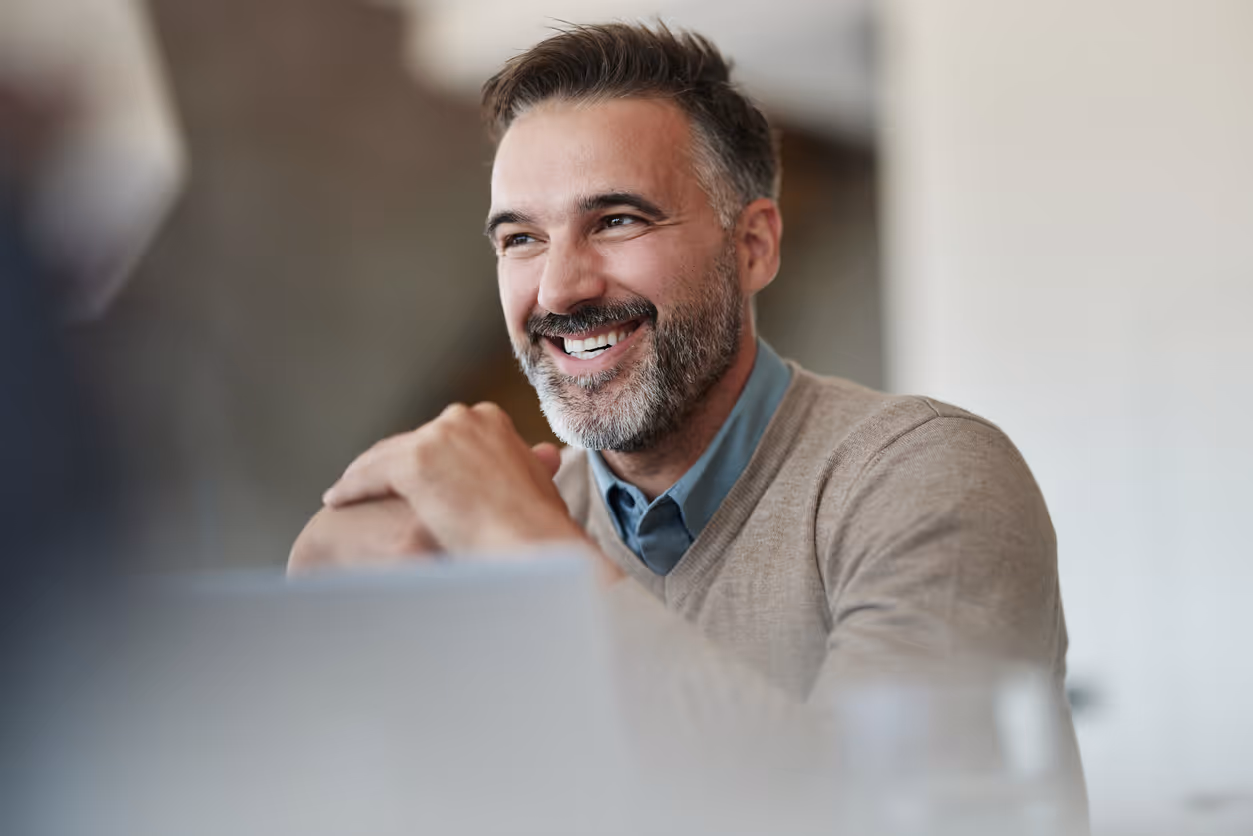 Nonprofit manager on a meeting with two of his team in his office.